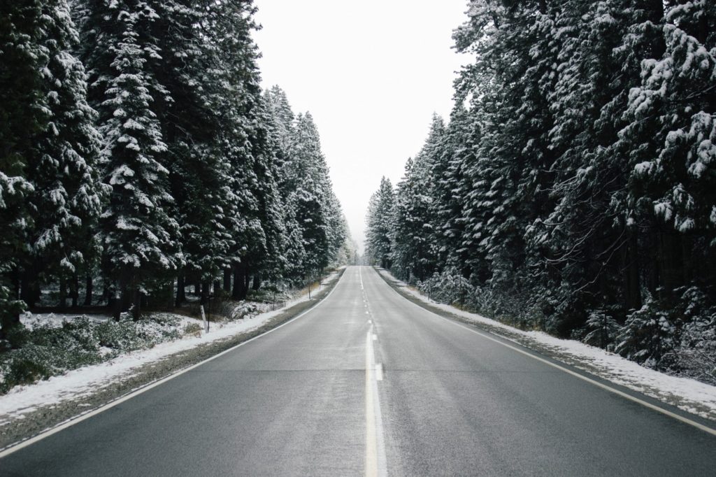 Your winter driving safety guide: image of an open country road in the wintertime.