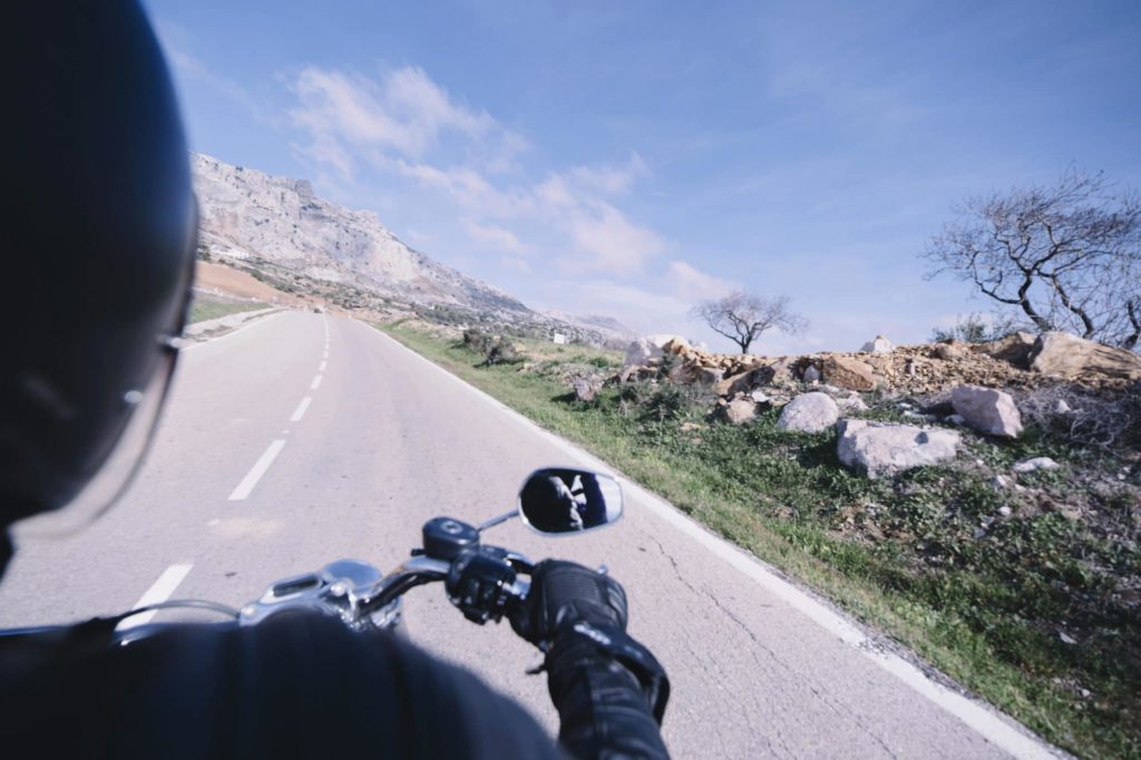 Tips to Help Prevent Motorcycle Accidents: image of a motorcyclist speeding on a mountain road.