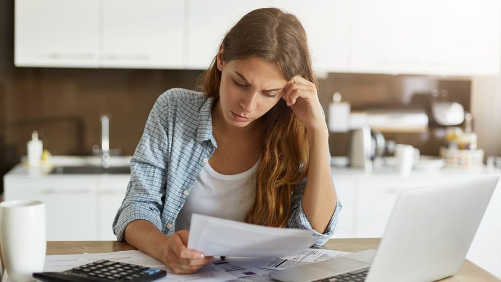 A woman reviews a personal injury document about pain and suffering claims written by Nelson Personal Injury LLC