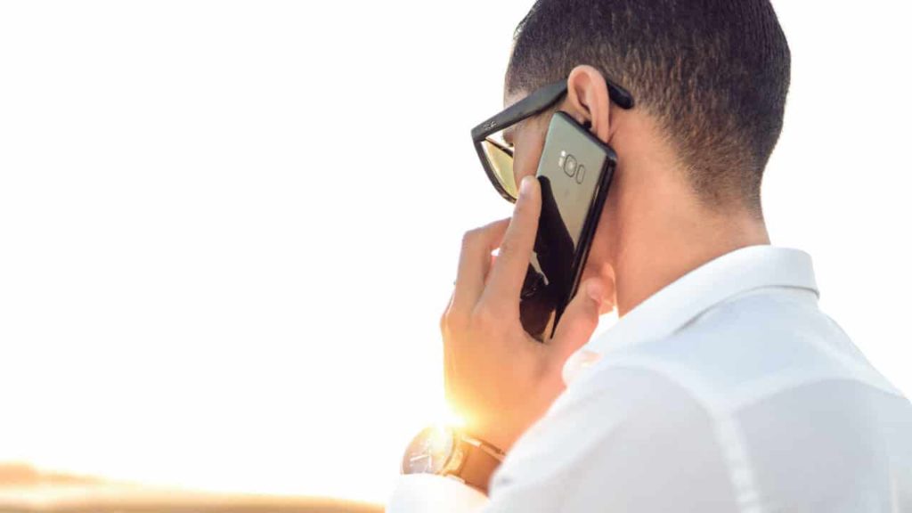 Man on the phone at an accident scene.