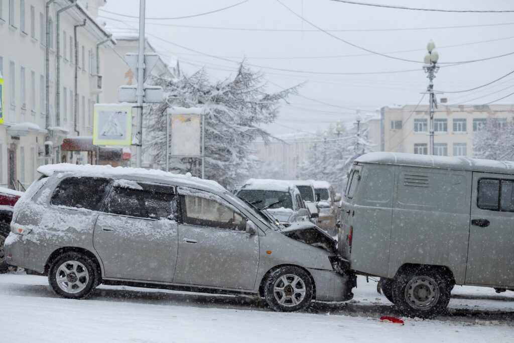 Cars involved in a winter crash on a snowy Minnesota street with icy road conditions